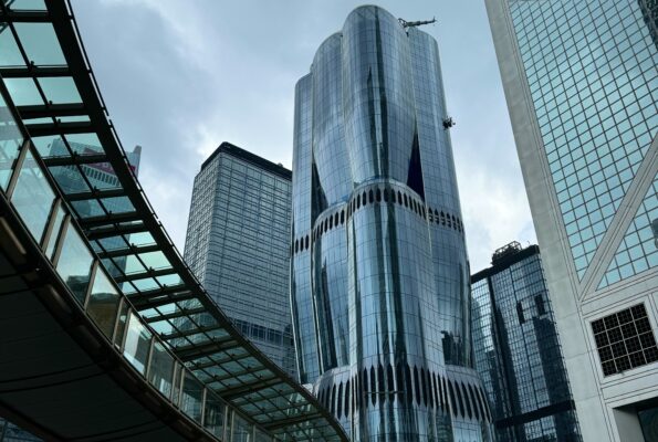 Skyscrapers with curved bridge in the view.