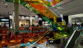 Colourful elevators inside New Yorks Saks Fifth shopping mall.