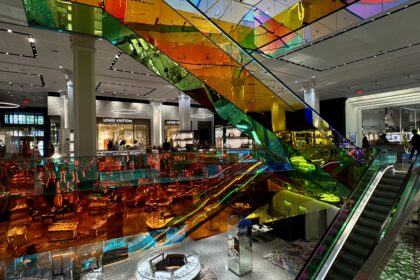 Colourful elevators inside New Yorks Saks Fifth shopping mall.