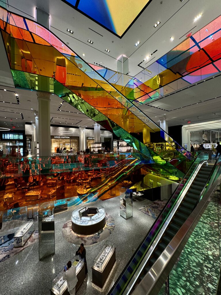 Colourful elevators inside New Yorks Saks Fifth shopping mall. 