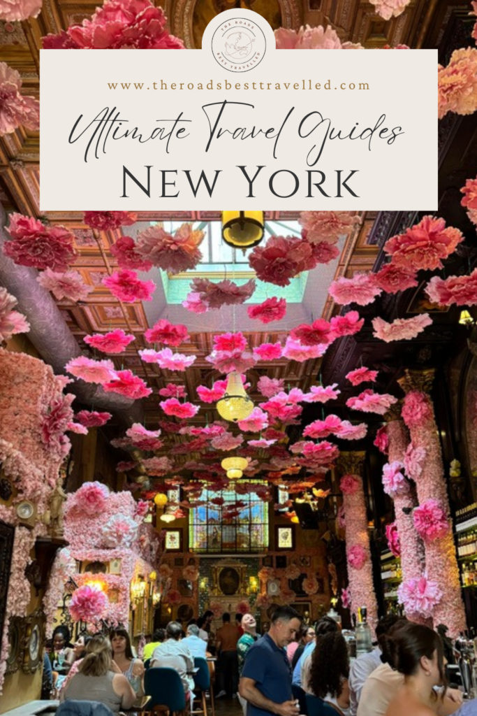 A restaurant with pink flowers hanging from the top. 