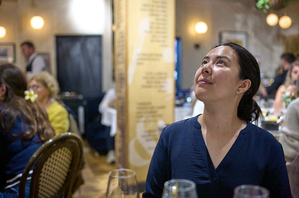 Woman looking into the light at a restaurant in paris france