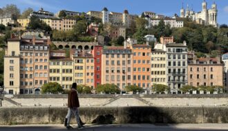 Man walking by the canals in Lyon.