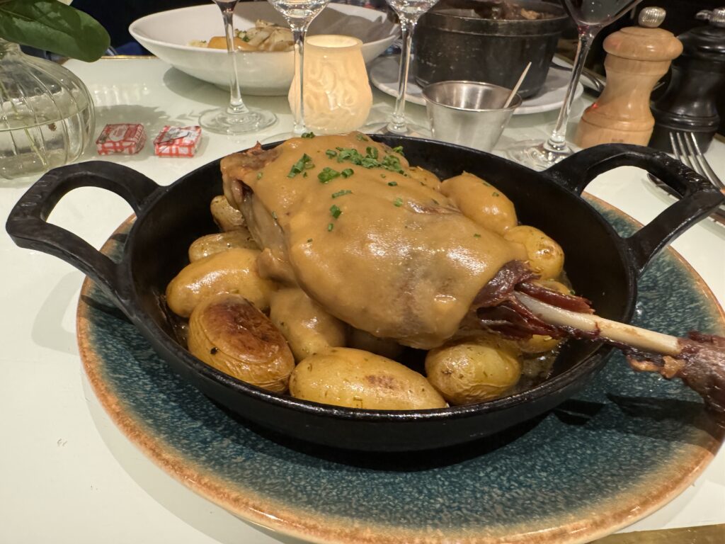 duck leg confit on a cast iron platter